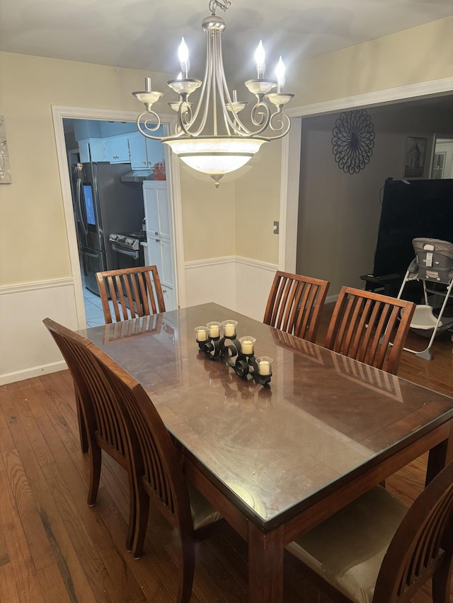 dining space featuring a notable chandelier and hardwood / wood-style flooring