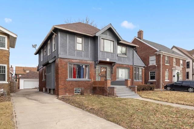 view of front of home featuring brick siding, stucco siding, and an outbuilding