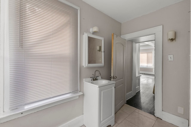 bathroom featuring tile patterned flooring, vanity, and baseboards