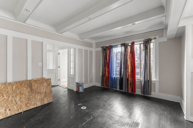 unfurnished room with beam ceiling, crown molding, and baseboards