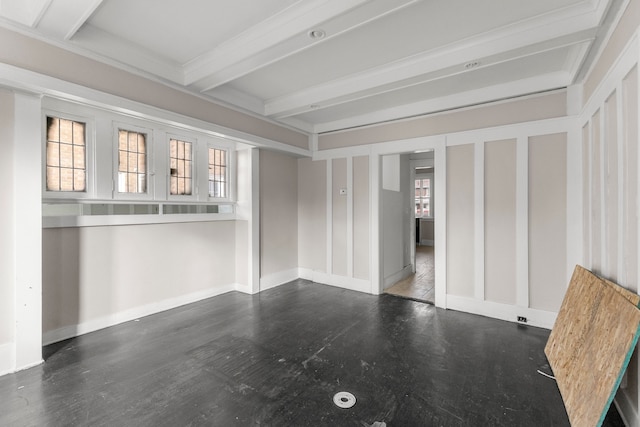 spare room featuring baseboards and beam ceiling