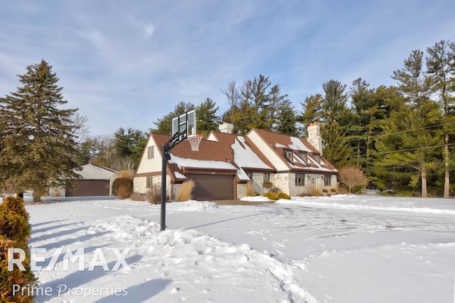 view of front of property featuring stone siding and an outdoor structure