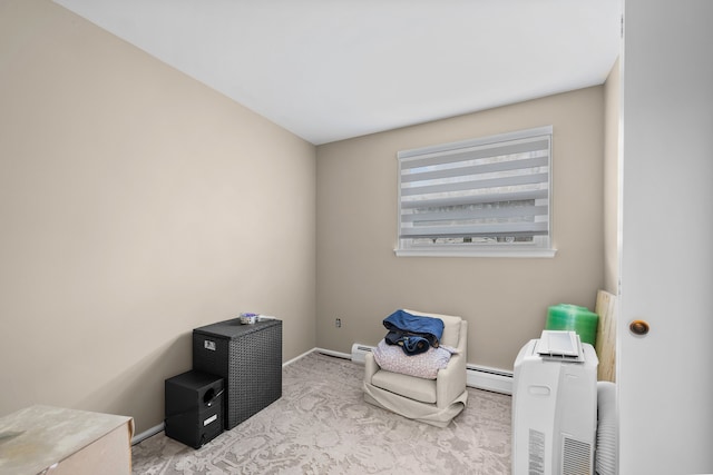 sitting room with carpet floors, baseboards, a baseboard heating unit, and a baseboard radiator