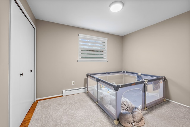 interior space with baseboard heating, a closet, and baseboards