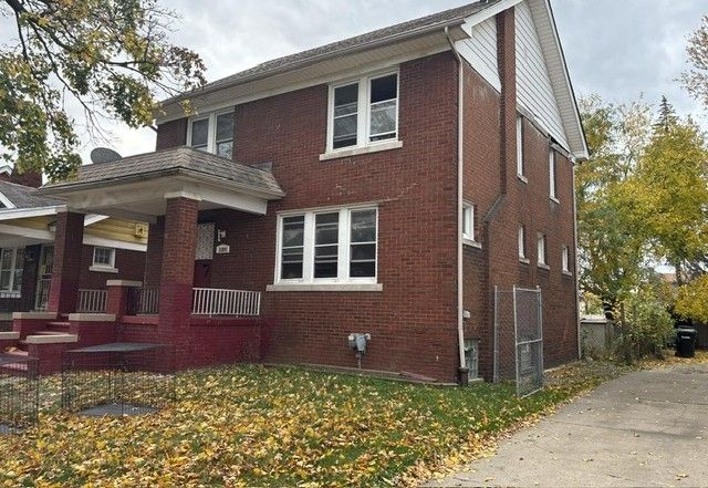 view of side of property featuring brick siding