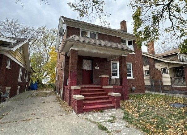 view of front of home featuring brick siding and a chimney