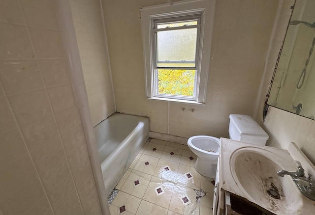 bathroom featuring toilet, a tub, tile patterned flooring, and vanity