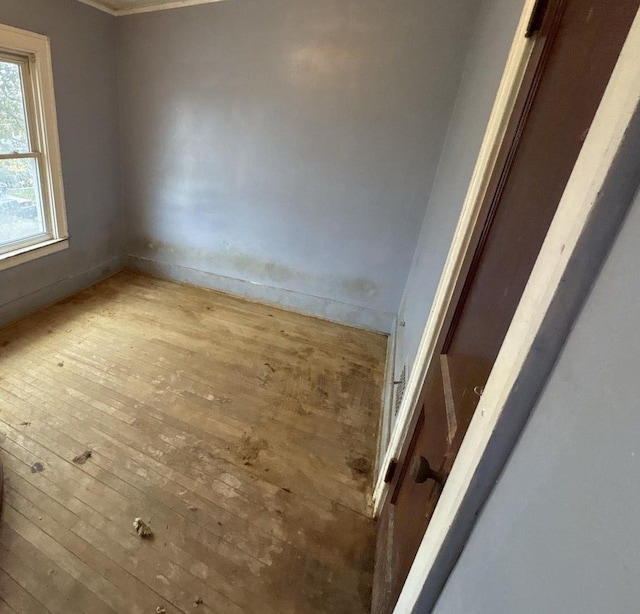 spare room with hardwood / wood-style floors and baseboards