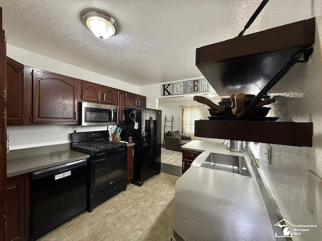 kitchen featuring dark brown cabinets, a textured ceiling, and black appliances