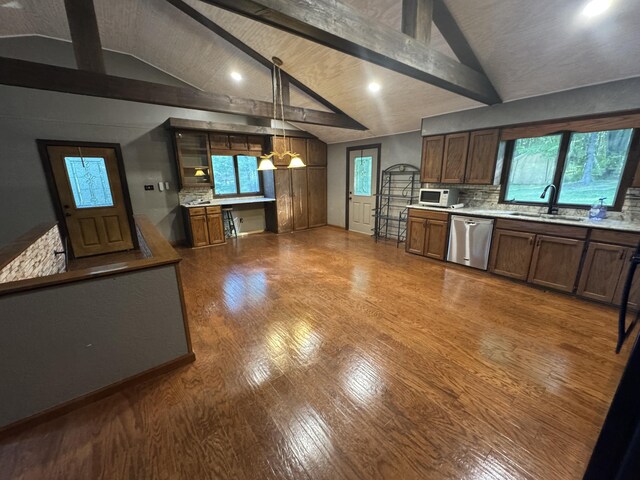 19084 200th Ave, Tustin, MI 49688 - kitchen with stainless steel dishwasher, light countertops, backsplash, dark wood finished floors, and white microwave