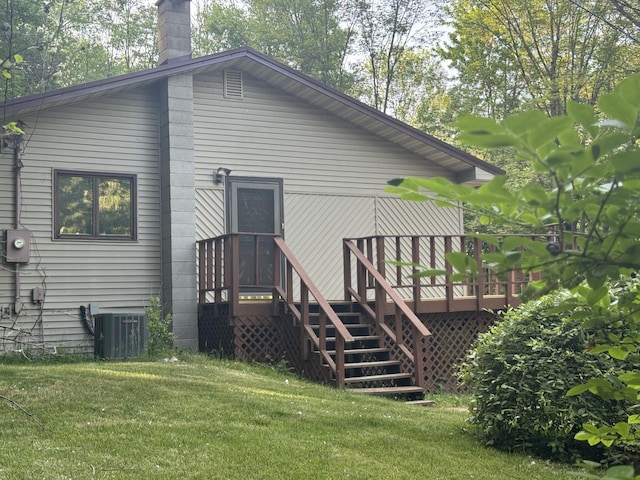 19084 200th Ave, Tustin, MI 49688 - back of house with a yard, a wooden deck, a chimney, and stairs
