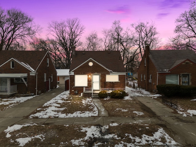 view of front facade featuring driveway and brick siding