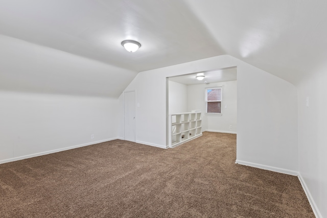 additional living space featuring lofted ceiling, carpet floors, and baseboards