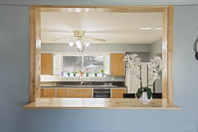 kitchen with ceiling fan and a sink