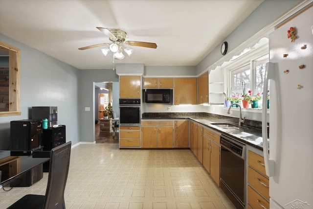 kitchen with a ceiling fan, dark countertops, light floors, black appliances, and a sink