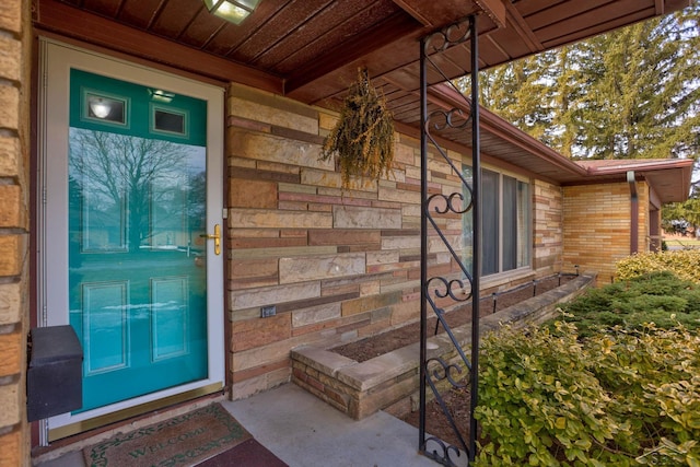 property entrance featuring brick siding