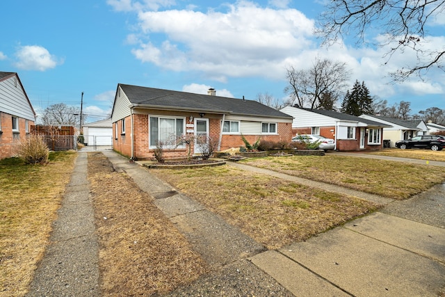 view of front of property featuring a front yard, fence, a chimney, a garage, and brick siding