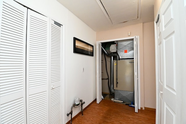 corridor with attic access, baseboards, and wood finished floors