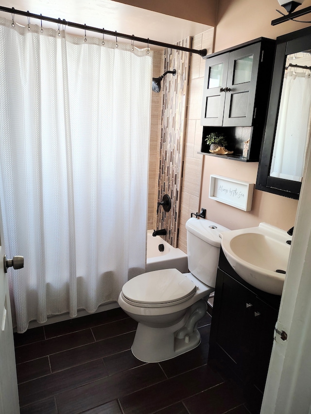 full bathroom with vanity, toilet, and shower / tub combo with curtain