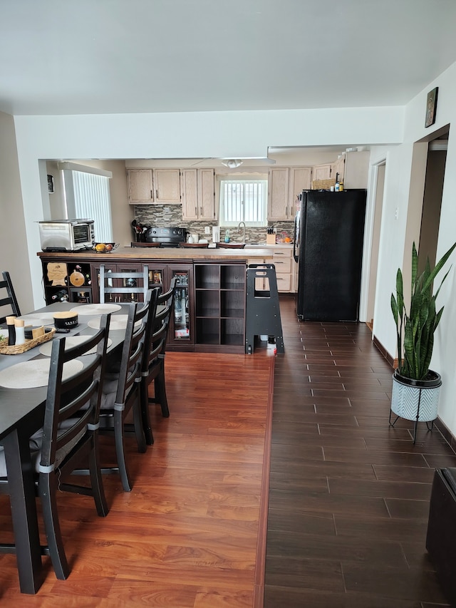 dining space with dark wood-style floors and a toaster