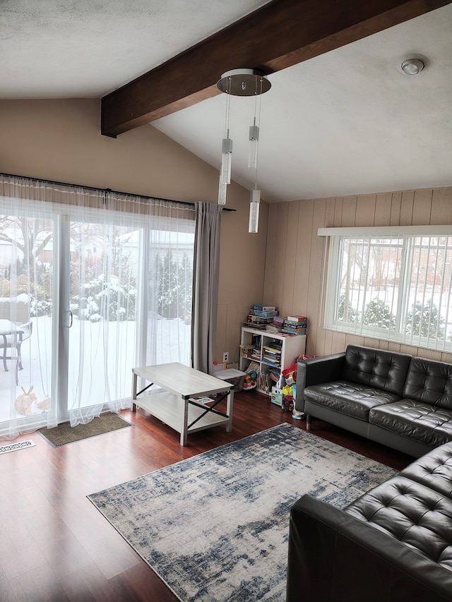 living area with lofted ceiling with beams and dark wood-style floors