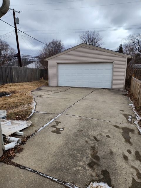 detached garage featuring fence