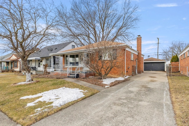 bungalow-style house with a detached garage, a porch, an outbuilding, a front lawn, and brick siding