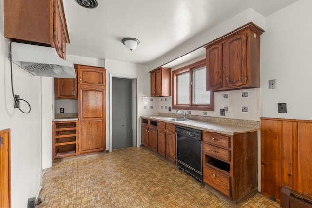 kitchen featuring black dishwasher, light countertops, a baseboard heating unit, brown cabinetry, and a sink