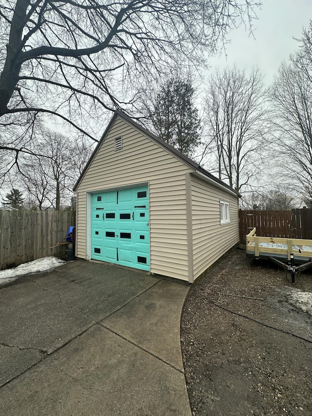 detached garage with driveway and fence