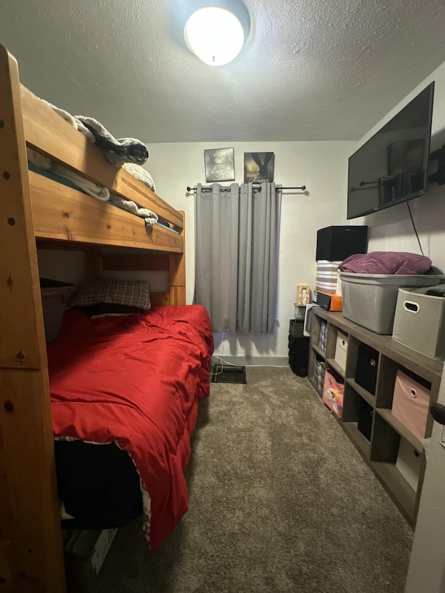 bedroom with a textured ceiling and carpet flooring