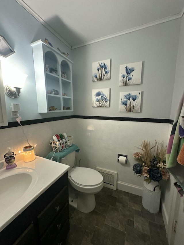 bathroom featuring visible vents, toilet, stone finish floor, crown molding, and vanity