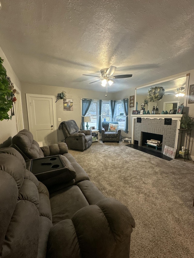 carpeted living room with a textured ceiling, a fireplace, and a ceiling fan