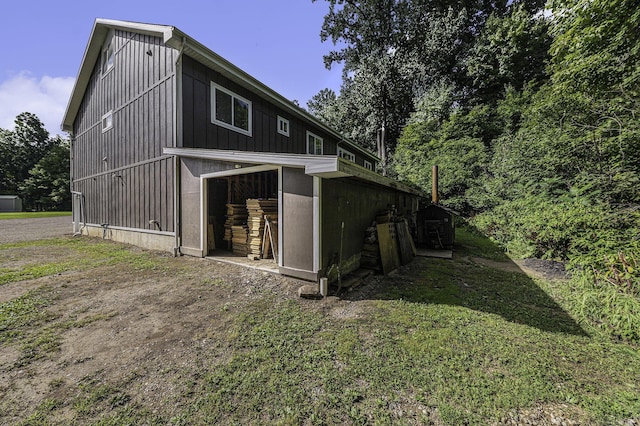 exterior space with board and batten siding and an outdoor structure