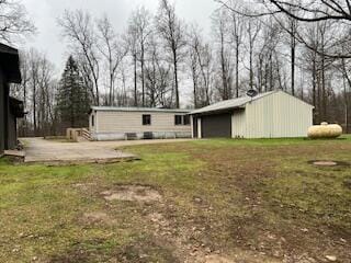 exterior space with an outbuilding, a yard, and a patio area