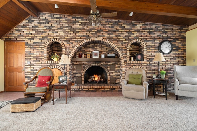 unfurnished room featuring vaulted ceiling with beams, a ceiling fan, wood ceiling, a brick fireplace, and carpet