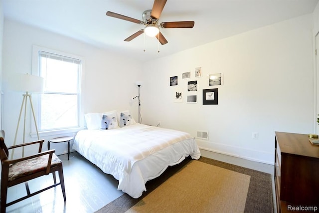 bedroom with a ceiling fan, visible vents, and baseboards