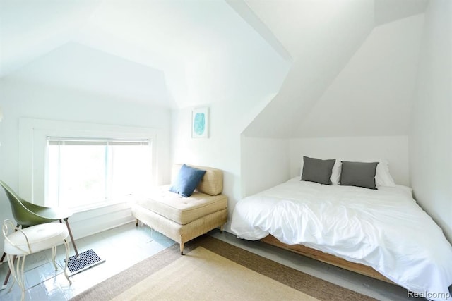 bedroom with lofted ceiling and visible vents