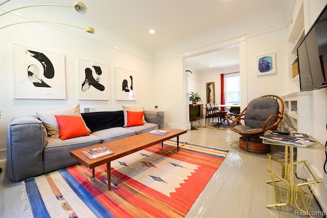 living room with light wood-style floors and recessed lighting