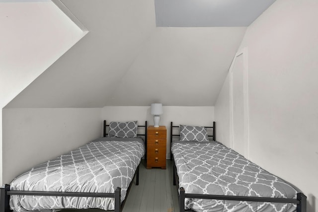 bedroom featuring lofted ceiling and hardwood / wood-style flooring