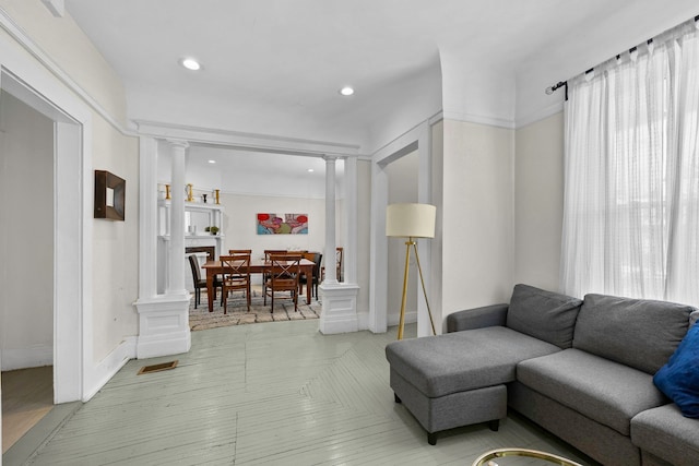 living room featuring visible vents, decorative columns, and recessed lighting