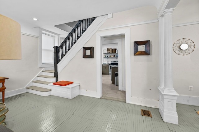 stairs featuring ornate columns, baseboards, visible vents, and recessed lighting