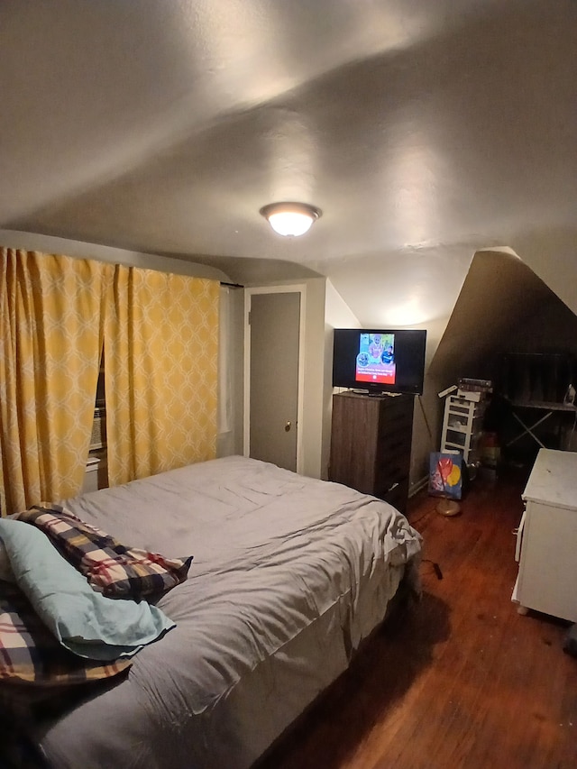 bedroom featuring vaulted ceiling and wood finished floors