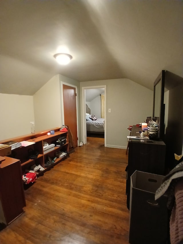 additional living space featuring lofted ceiling and wood finished floors