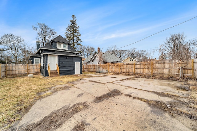 exterior space with entry steps, a patio area, and a fenced backyard