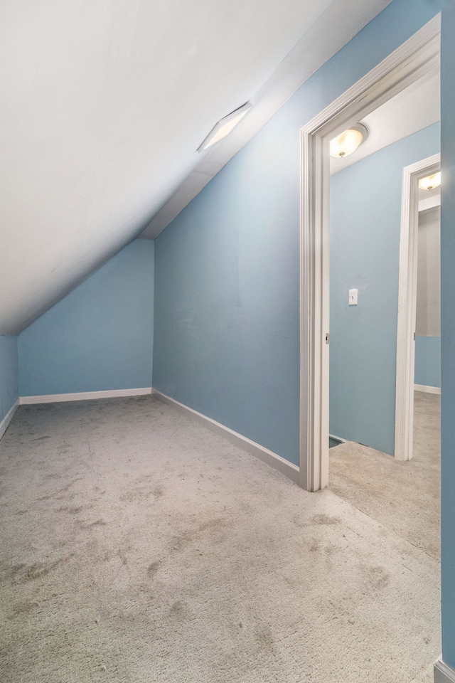 bonus room featuring lofted ceiling and carpet flooring