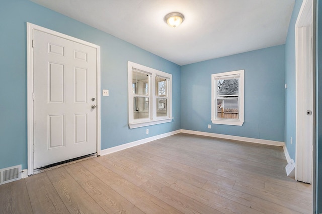 entrance foyer with visible vents, light wood-style flooring, and baseboards