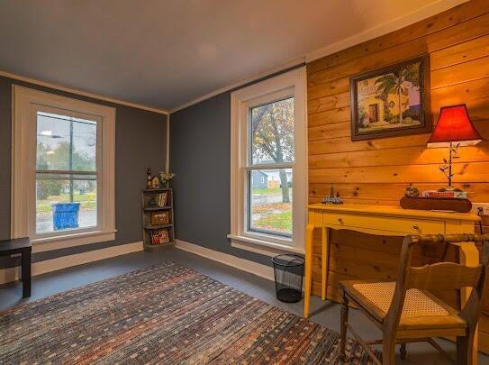 sitting room featuring baseboards and a healthy amount of sunlight