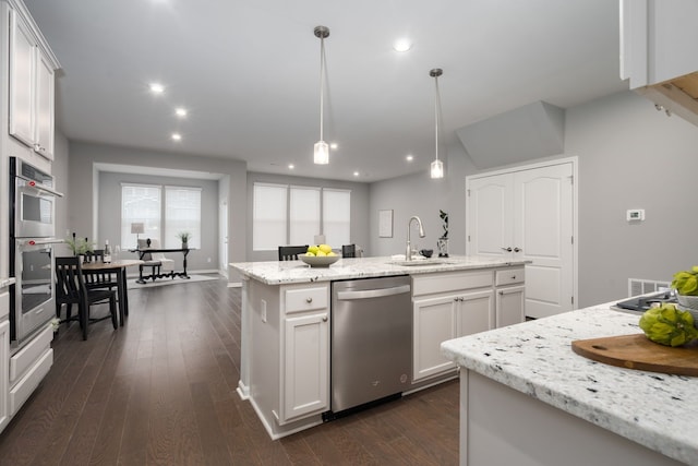 kitchen with recessed lighting, stainless steel appliances, a sink, dark wood finished floors, and pendant lighting