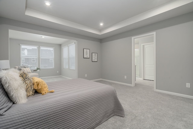 bedroom with recessed lighting, carpet flooring, a raised ceiling, and baseboards