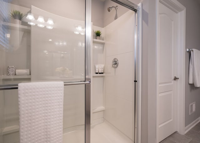 bathroom featuring a shower stall and tile patterned floors